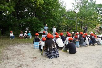 ビオトープ同好会の方の説明を聞く生徒の写真